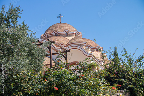 View on backyard of Monastery of Archangel Michael in Greece, Thasos Island, with vivid orange walls and roof, monastery was build at the cliff over the Aegean Sea, which first began as a men's only photo