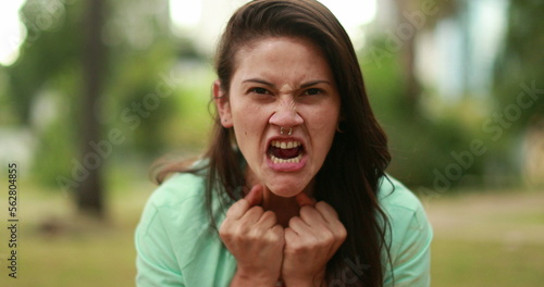 Φωτογραφία Angry young woman screaming from the top of her lungs feeling distraught