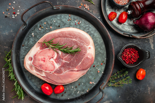 Canvas Print Raw pork ham cut on a dark background, banner, menu, recipe place for text, top