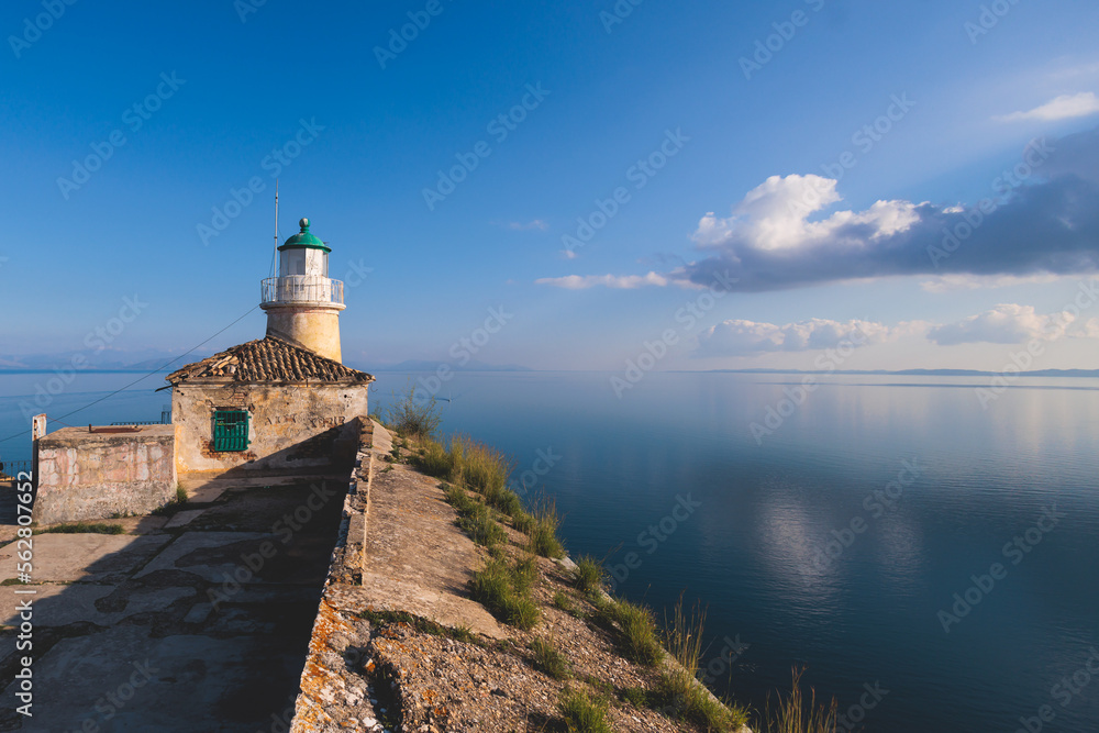 View of Old Venetian Fortress of Corfu, Palaio Frourio, Kerkyra old town, Greece, Ionian sea islands, with the lighthouse, Clock tower, st. George church and the city, a blue sky summer sunny day