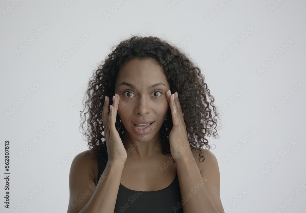 CU Portrait of attractive African-American female doing her skincare routine. Studio shot, soft lighting. No make up, clean skin. Shot with ARRI Alexa Mini LF CU Portrait of attractive African-American female doing her skincare routine. Studio shot, soft lighting. No make up, clean skin. Shot with ARRI Alexa Mini LF
