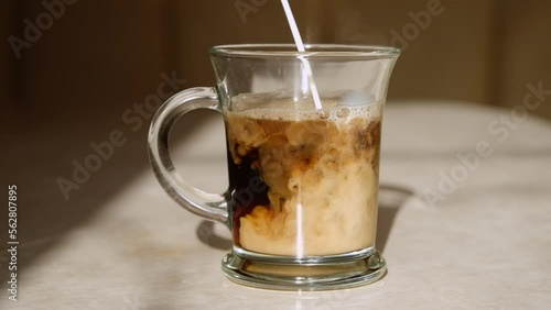Add milk to instant coffee, slow motion.