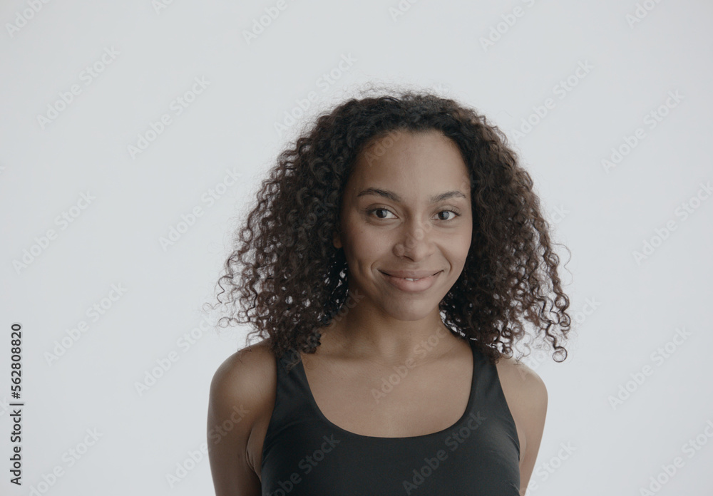 CU Headshot portrait of beautiful 20s African-American Black female posing against white background, no make-up, clean skin. Shot with ARRI Alexa Mini LF CU Headshot portrait of beautiful 20s African-American Black female posing against white background, no make-up, clean skin. Shot with ARRI Alexa Mini LF