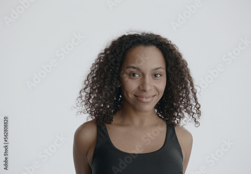CU Headshot portrait of beautiful 20s African-American Black female posing against white background, no make-up, clean skin. Shot with ARRI Alexa Mini LF
