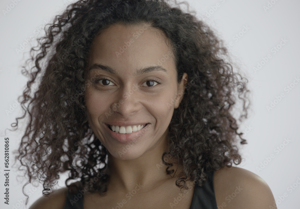 CU Headshot portrait of beautiful 20s African-American Black female posing against white background, no make-up, clean skin. Shot with ARRI Alexa Mini LF CU Headshot portrait of beautiful 20s African-American Black female posing against white background, no make-up, clean skin. Shot with ARRI Alexa Mini LF