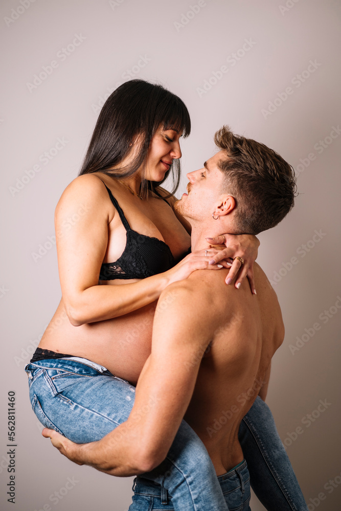 Happy couple embracing in studio Happy couple embracing in studio