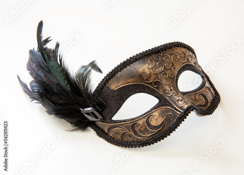 Carnival Venetian mask with black feather decoration isolated on white photo