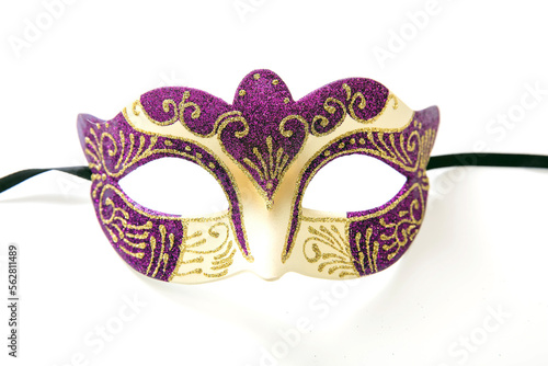 Carnival Venetian mask with purple and gold color glitter isolated on white