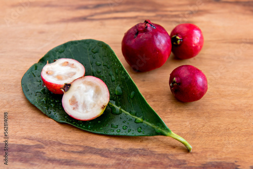 Cattley guava, red Psidium cattleyanum fruit on the table. photo