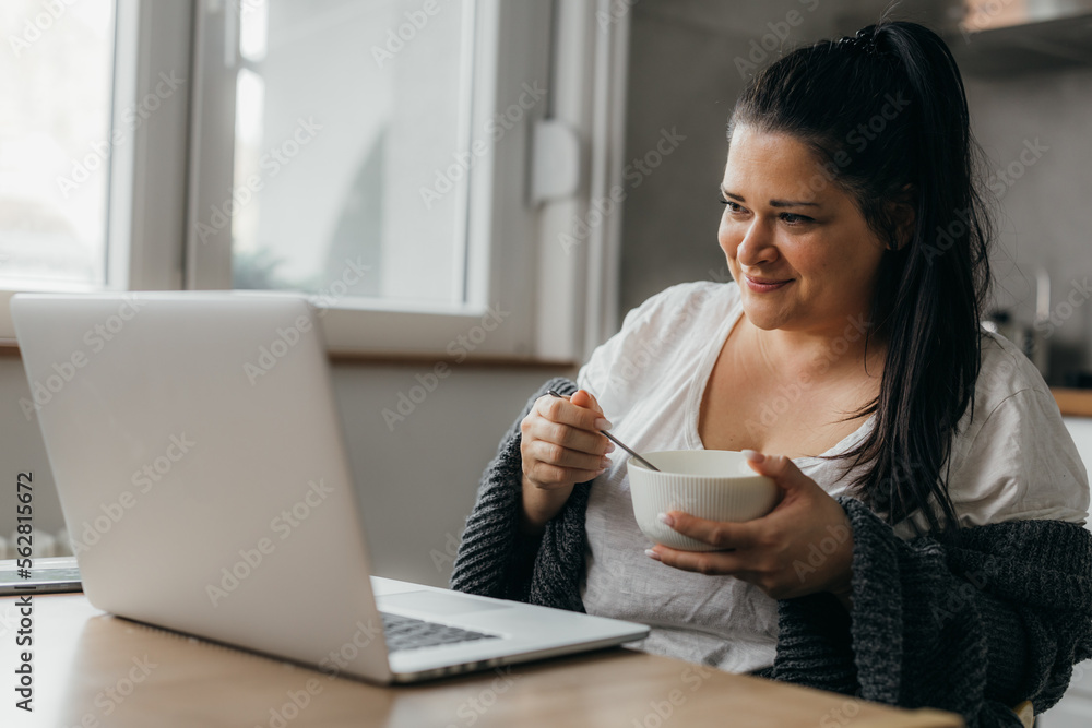 Middle aged woman works remotely from home