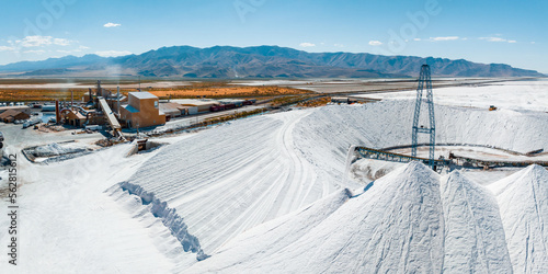Salt Lake City, Utah landscape with desert salt mining factory at lake Bonneville with piles of white mineral and industrial equipment photo