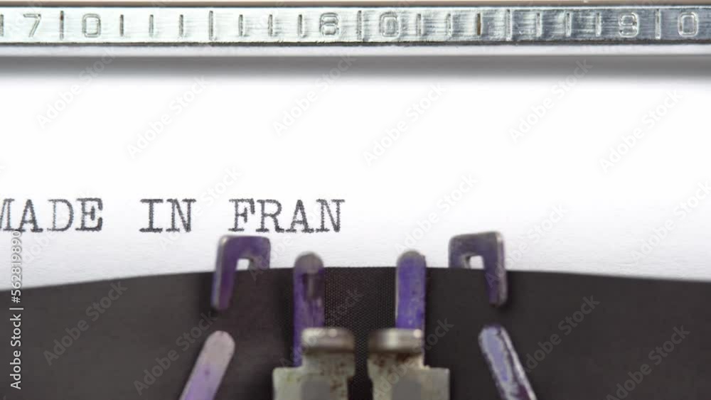 Made In France phrase closeup being typing and centered on a sheet of paper on old vintage typewriter mechanical Made In France phrase closeup being typing and centered on a sheet of paper on old vintage typewriter mechanical