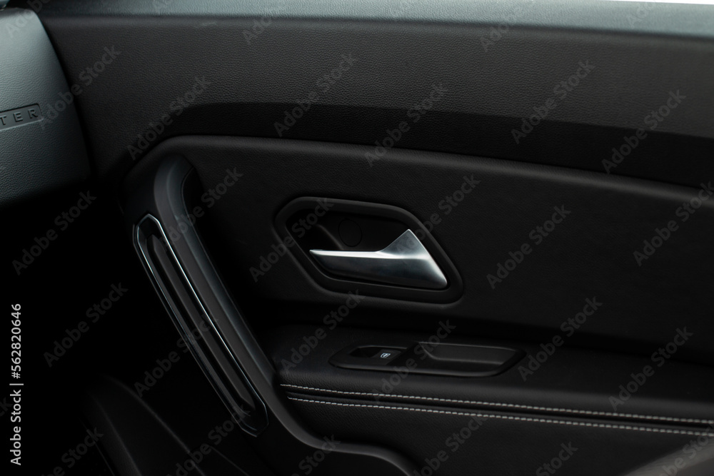 Modern car interior door panel. Car detailing.