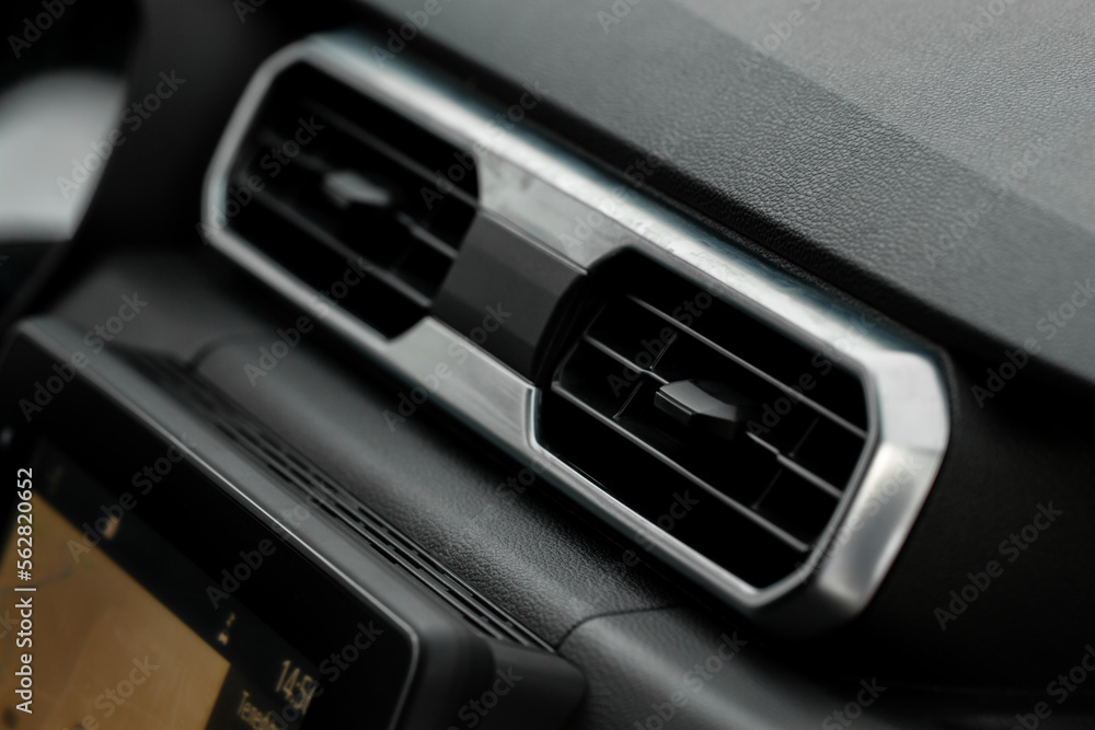 Car air conditioning close up view. The air conditioner flow inside the car. Detail interior of car. Air ducts. Car air conditioning close up view. The air conditioner flow inside the car. Detail interior of car. Air ducts.