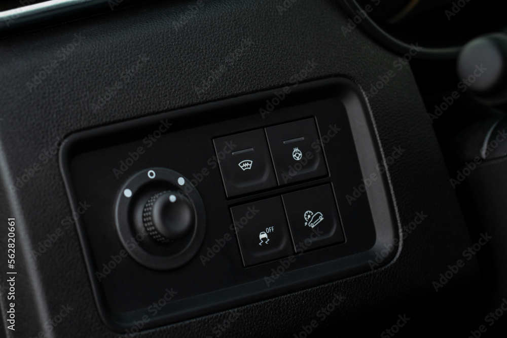 Hand operating ESP (electronic stability program) control close up view. Interior detail of a modern car. ESP button. Hand operating ESP (electronic stability program) control close up view. Interior detail of a modern car. ESP button.