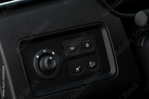 Hand operating ESP (electronic stability program) control close up view. Interior detail of a modern car. ESP button. © Roman