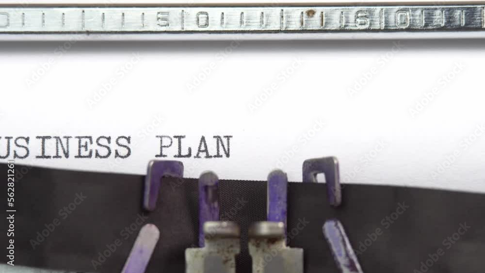 Business plan phrase closeup being typing and centered on a sheet of paper on old vintage typewriter mechanical Business plan phrase closeup being typing and centered on a sheet of paper on old vintage typewriter mechanical