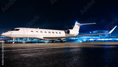 Schilderij op canvas Private jet parked at night, making an elegant aviation background