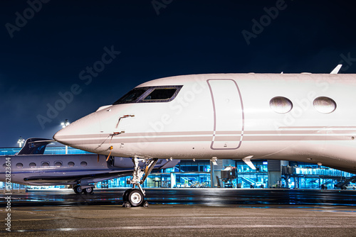 Private jet parked at night, making an elegant aviation background. Business jet is the way to travel for millionairs. This jet was parked at Zurich airport during the world economic forum (WEF)