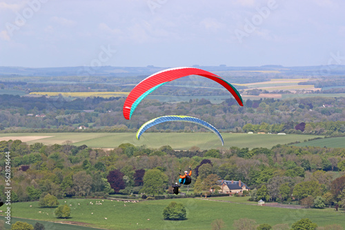 Paragliders flying from a hill 
