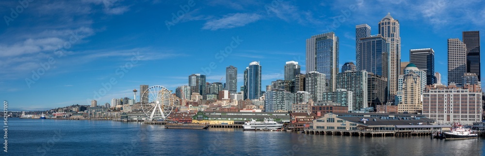 Seattle, Washington - Jan. 23 Panoramic view of Seattle Downtown Skyline with modern skyscrapers , Waterfront with piers, The Seattle Great Wheel and Space Needle. View from Elliott Bay Seaside. Seattle, Washington - Jan. 23 Panoramic view of Seattle Downtown Skyline with modern skyscrapers , Waterfront with piers, The Seattle Great Wheel and Space Needle. View from Elliott Bay Seaside.