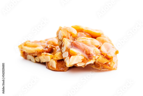 Sweet peanut brittle. Tasty peanuts in caramel isolated on white background. photo