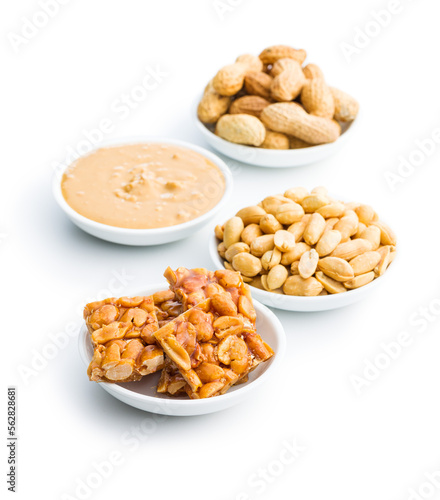 Sweet peanut brittle, peanuts and peanuts butter isolated on white background.