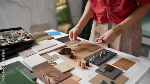 Woman architect puts samples on a table in the office