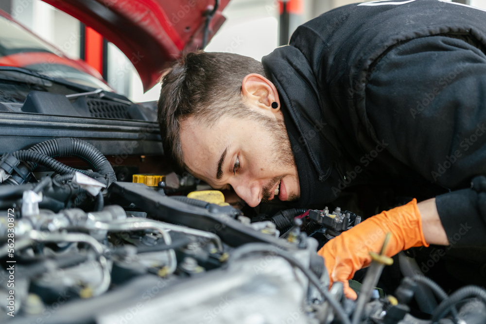 Car mechanic working in a garage
