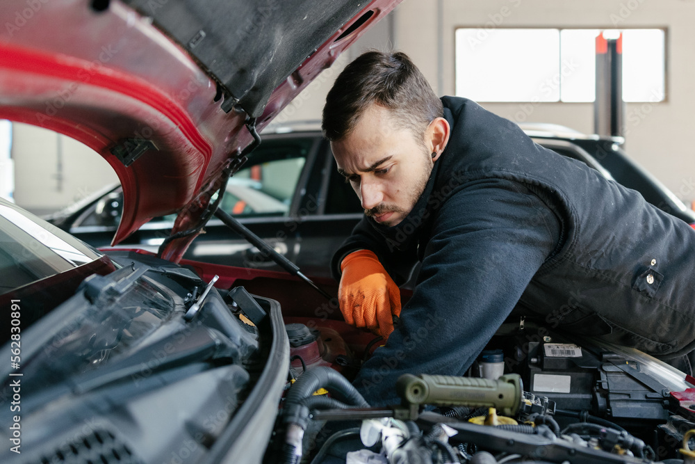 Car mechanic working in a garage Car mechanic working in a garage