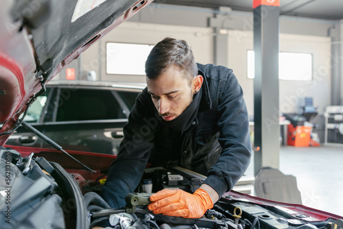 Car mechanic working in a garage