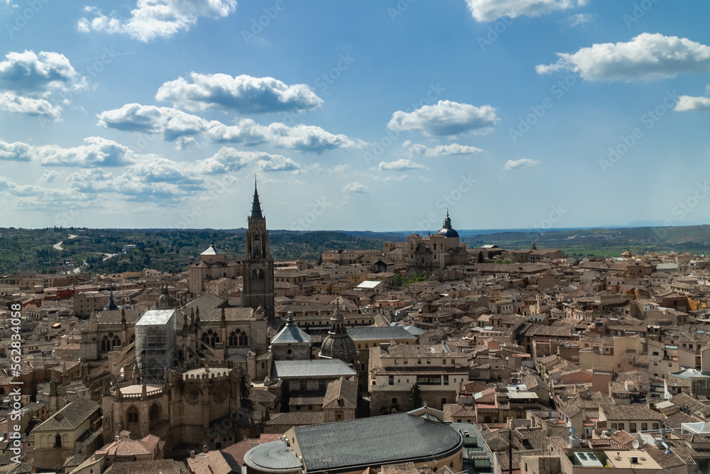 Toledo, España. April 29, 2022: Toledo Cathedral with blue sky and panoramic city landscape.