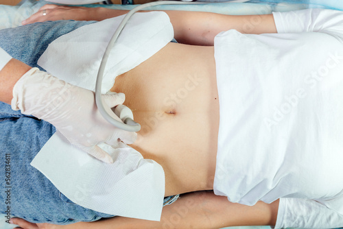 Doctor ultrasound examine female patient abdomen at hospital