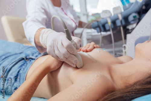 Slika na platnu Young woman getting breast examination by her gynecologist ultrasound scanning