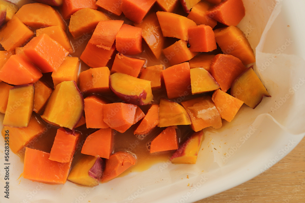 diced sweet potato baked in the oven on a baking sheet diced sweet potato baked in the oven on a baking sheet