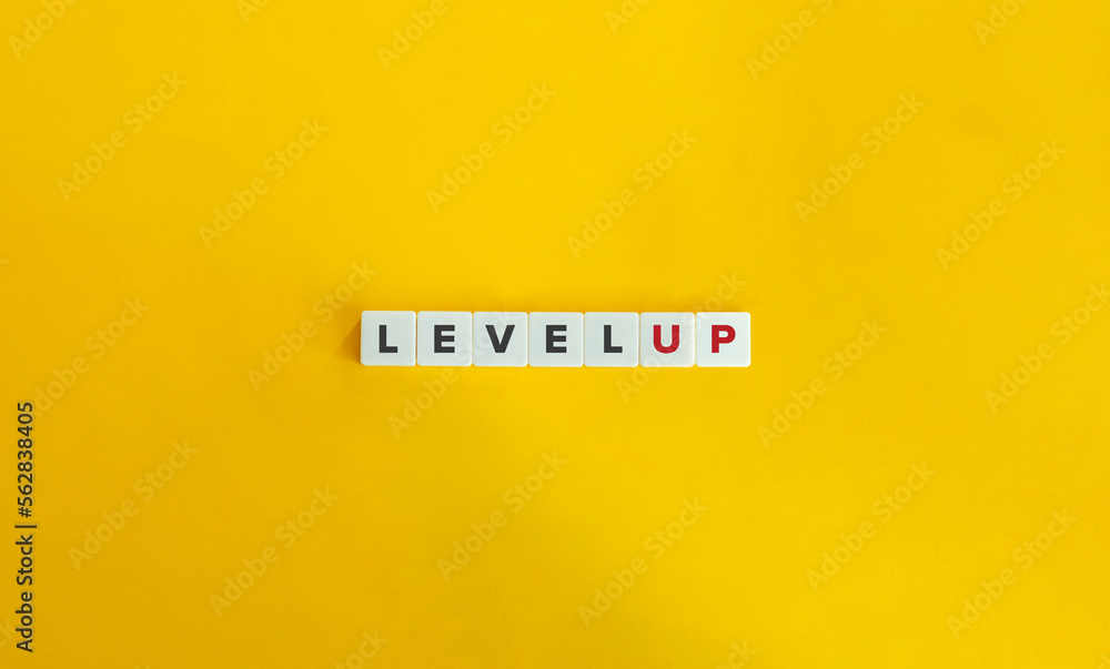 Level Up Banner. Letter Tiles on Yellow Background. Minimal Aesthetics. Level Up Banner. Letter Tiles on Yellow Background. Minimal Aesthetics.
