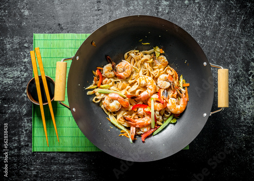 Delicious Chinese Udon noodles with shrimp, sauce and vegetables.