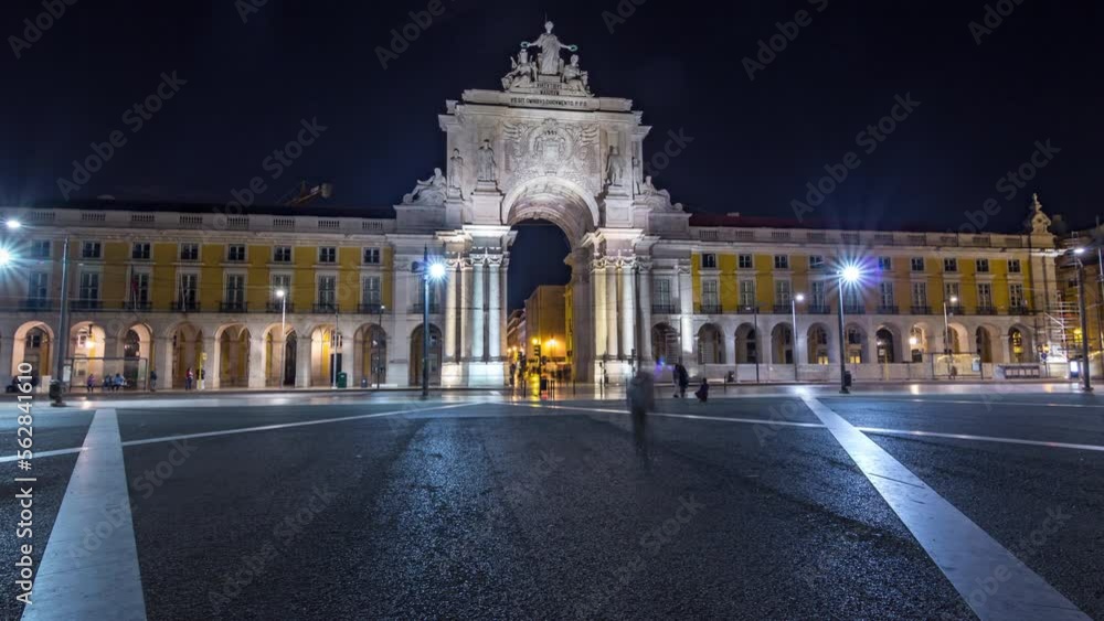 Triumphal arch at Rua Augusta at Commerce square illuminated at night timelapse hyperlapse in Lisbon, Portugal. People walking around Triumphal arch at Rua Augusta at Commerce square illuminated at night timelapse hyperlapse in Lisbon, Portugal. People walking around