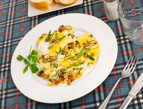 Traditional Spanish breakfast is a Revuelto, which is an omelet with chicken and mushrooms with asparagus. Decorated with a ..sprig of fresh greenery