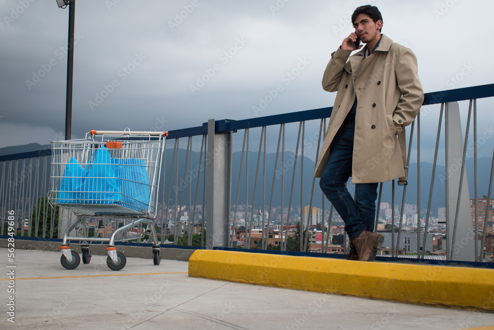 Market car and man talking on his phone in a parking Market car and man talking on his phone in a parking