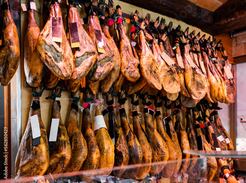 Legs of traditional Spanish jamon ready for sale in grocery photo