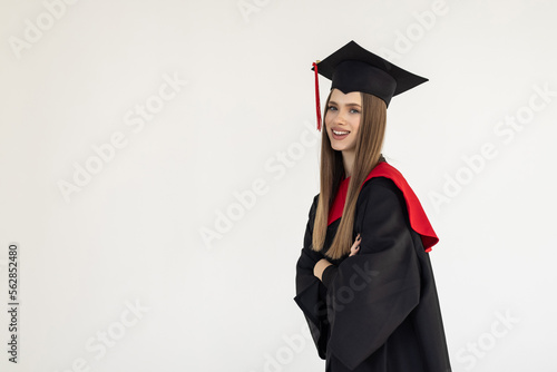 Картината върху платно Graduate womanwith master degree in black graduation robe and cap on white background
