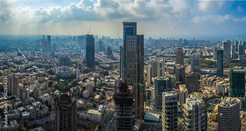 Aerial view of tel aviv and Ramat Gan skyline with urban skyscrapers at sunset, with cloudy sky, Israel