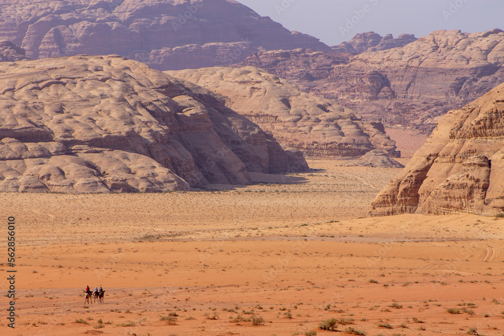 Horsemen traveling the desert landscape of Wadi Rum in Jordan in the Middle East