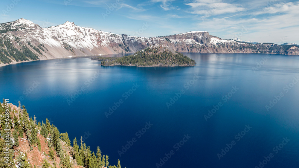 sunny morning in the snow covered Crater Lake National Park, Oregon, USA