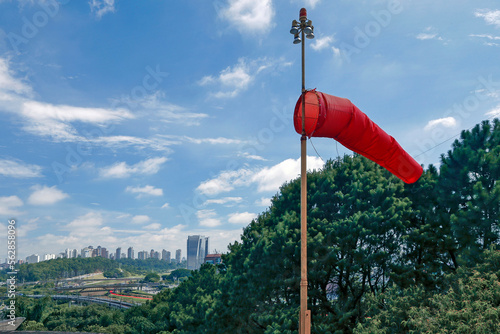 Red windsock inflated of air in heliport in Sao Paulo city, Brazil photo