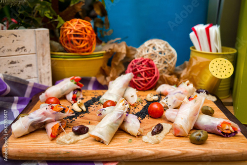 spring rolls on a wooden board, beautifully decorated appetizers