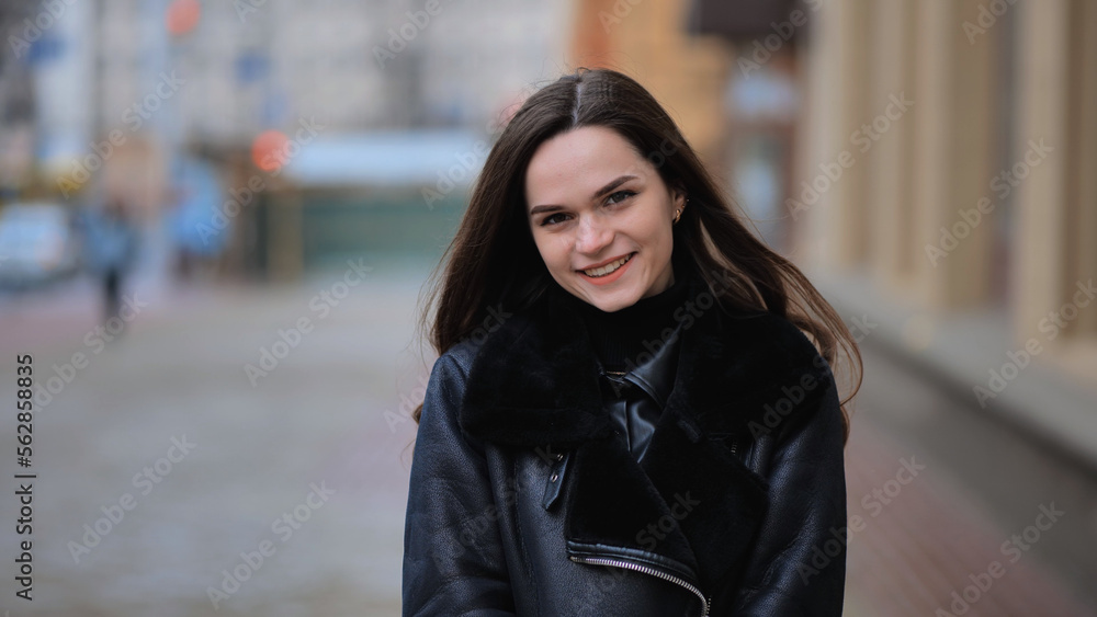 Portrait of a posing happy girl in the city in early spring. Portrait of a posing happy girl in the city in early spring.