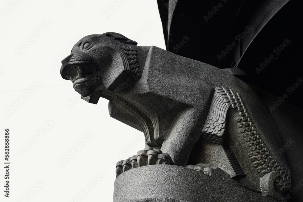 Large gargoyle in the shape of a fierce feline. Art Deco style stone