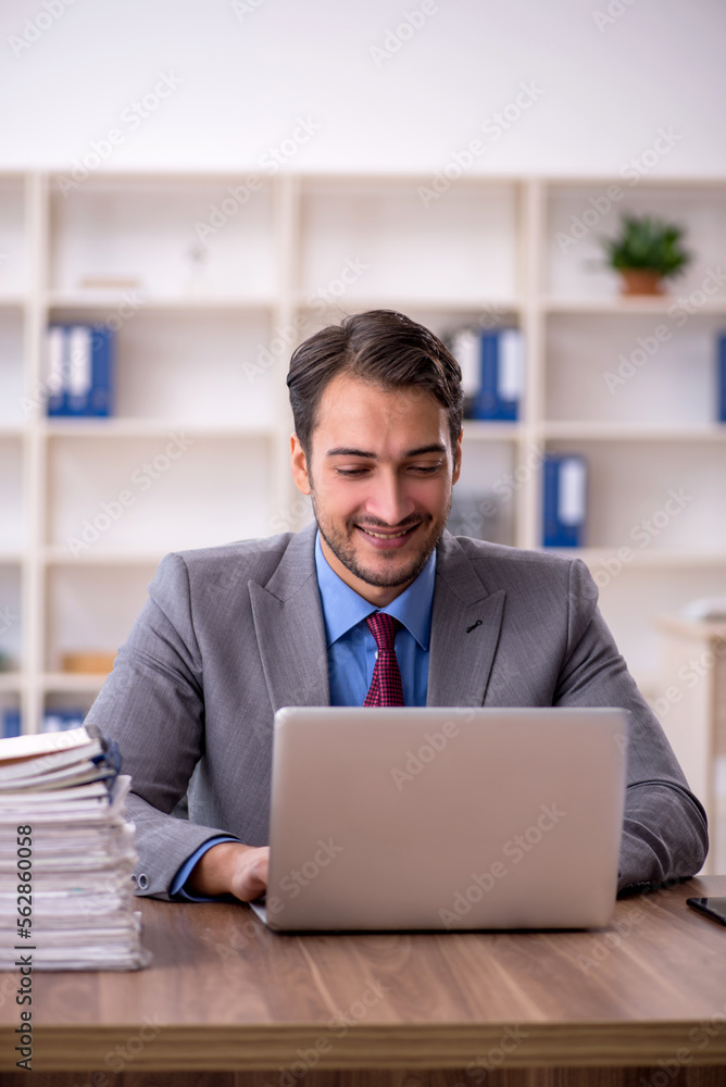 Young male employee working in the office Young male employee working in the office